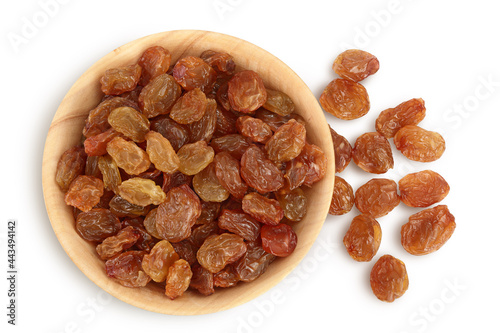 Brown raisins in wooden bowl isolated on white background with clipping path. Top view. Flat lay