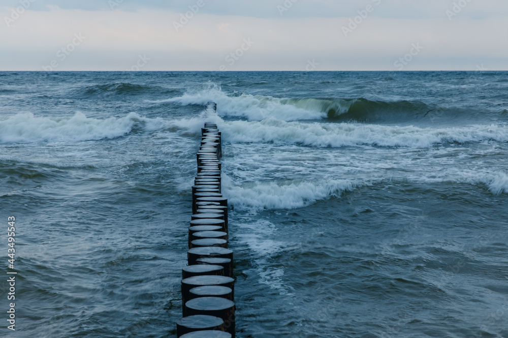 rough waves in the baltic sea, breakwater on the coast.