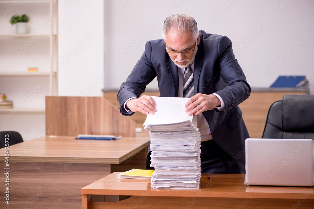 Old male employee and too much work in the office Old male employee and too much work in the office