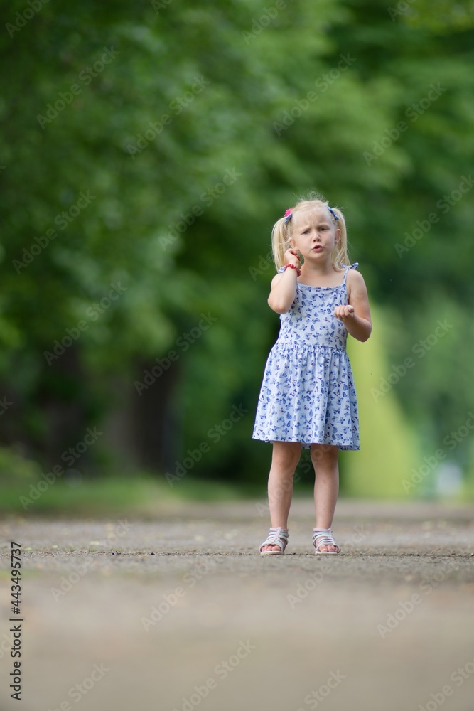 Little blond girl in the park portrait. Little blond girl in the park portrait.