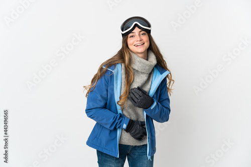 Skier girl with snowboarding glasses isolated on white background smiling a lot