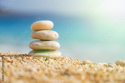 Pyramid Stones Balance at sea background with sunlight. Balanced stones