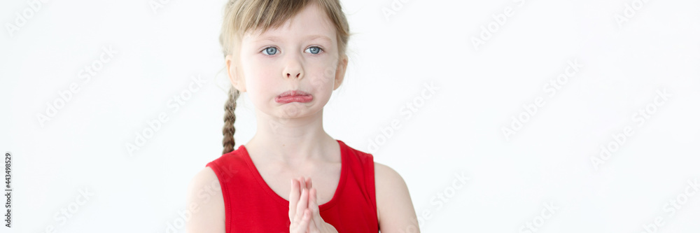Portrait of little offended girl with blue eyes