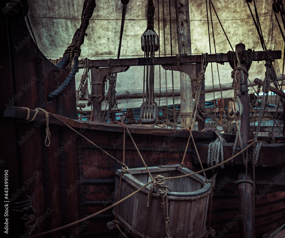 Old pirate ship with sail mast and ropes as gloomy vintage retro
