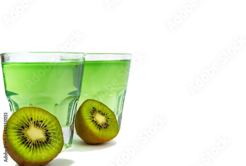 Sweet dessert, kiwi jelly in glass glasses and next to fresh kiwi, cut in half, isolate