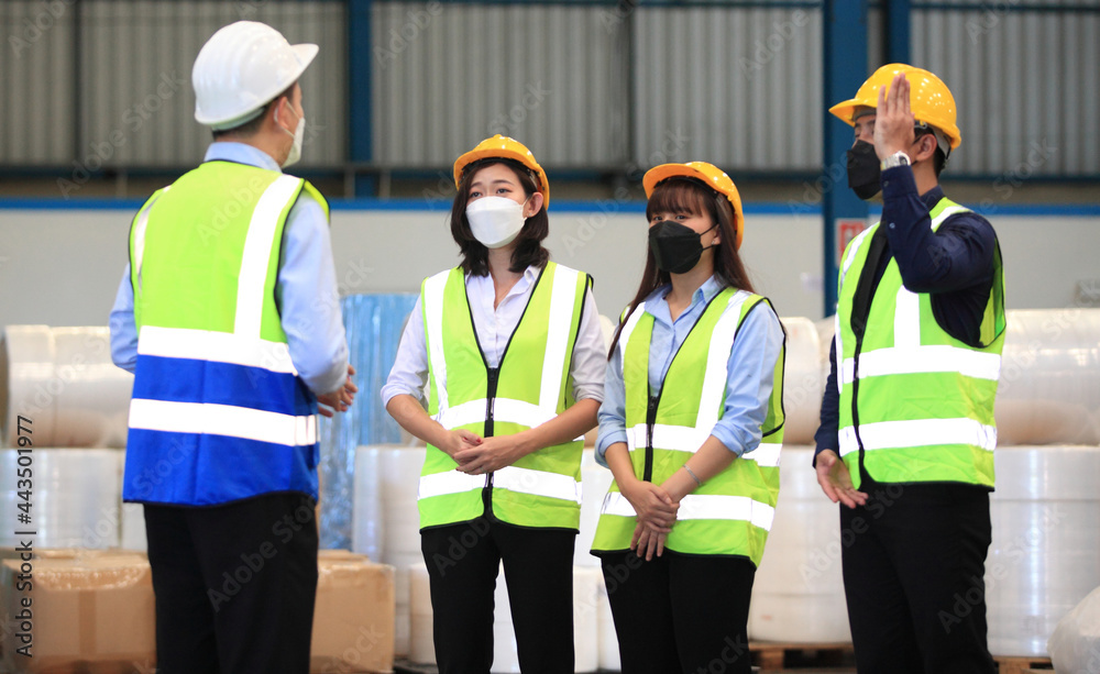 Team workers wear protective face masks for safety industrial factory. worker meeting before start working in factory or warehouse
