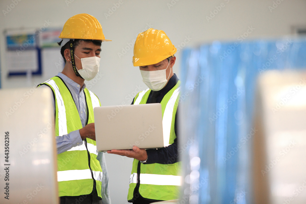 Team workers wear protective face masks for safety industrial factory. worker meeting before start working in factory or warehouse Team workers wear protective face masks for safety industrial factory. worker meeting before start working in factory or warehouse