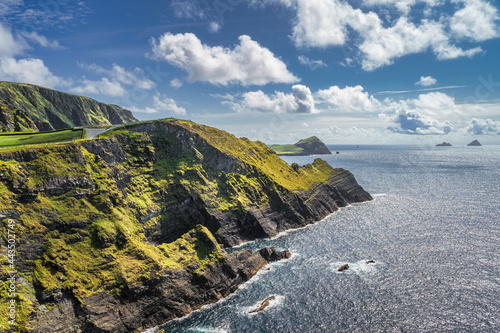 Canvas Print Tall Kerry Cliffs illuminated by sunlight and a view on Skellig Michael island