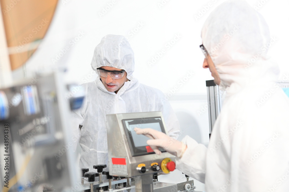 Production engineer with face mask working in factory , Qc engineer checking mask for good quality , Concept of protective action and quarantine to stop spreading of Coronavirus Disease 2019 Production engineer with face mask working in factory , Qc engineer checking mask for good quality , Concept of protective action and quarantine to stop spreading of Coronavirus Disease 2019