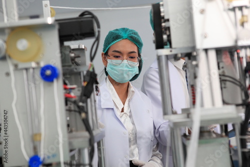 Production engineer with face mask working in factory   Qc engineer checking mask for good quality   Concept of protective action and quarantine to stop spreading of Coronavirus Disease 2019 