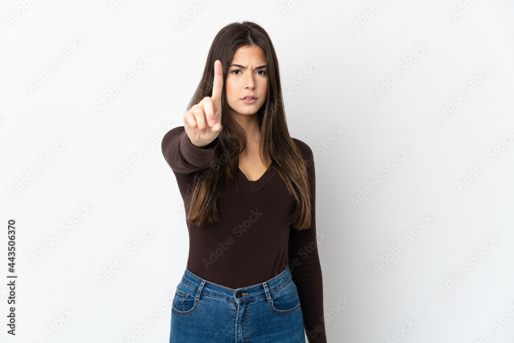 Teenager Brazilian girl isolated on white background counting one with serious expression Teenager Brazilian girl isolated on white background counting one with serious expression