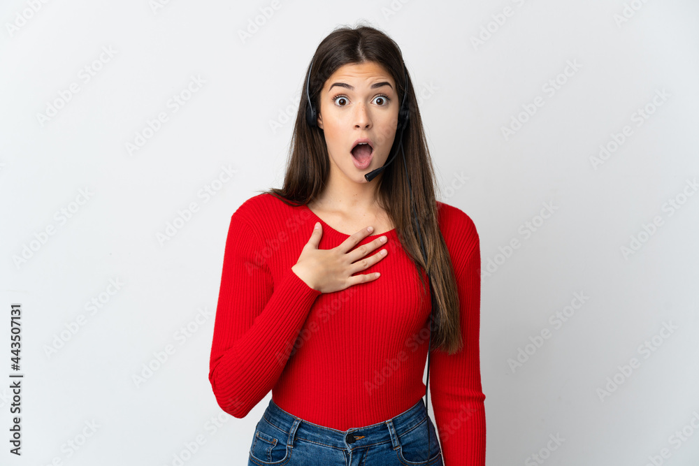 Young Brazilian telemarketer girl over isolated background surprised and shocked while looking right Young Brazilian telemarketer girl over isolated background surprised and shocked while looking right