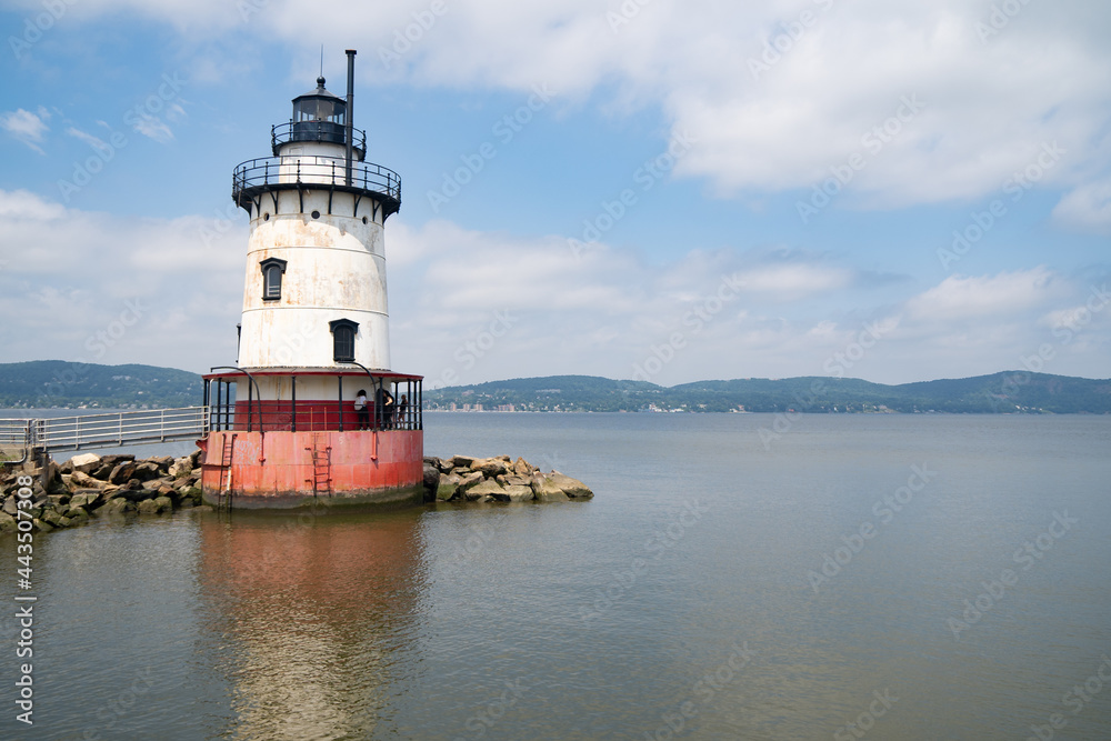 Sleepy Hollow, NY - USA - July 5, 2021: a horizontal view of the scenic Tarrytown Light, a sparkplug lighthouse on the east side of the Hudson River in Sleepy Hollow.