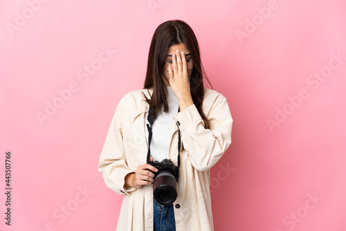 Young photographer Brazilian girl isolated on pink background with tired and sick expression © luismolinero