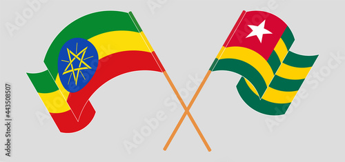 Crossed and waving flags of Ethiopia and Togo