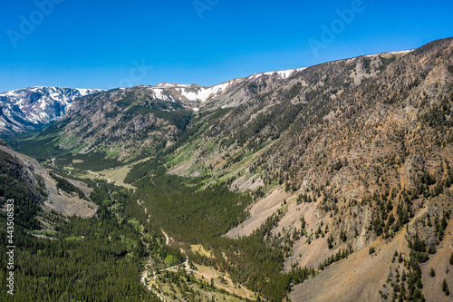 Aerial view of valley located in high Montana mountains near iconic town Red Lodge. Snow on the peak tops.