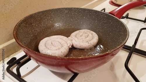 German style spiral fried sausages for beer. Fried in a pan in vegetable oil