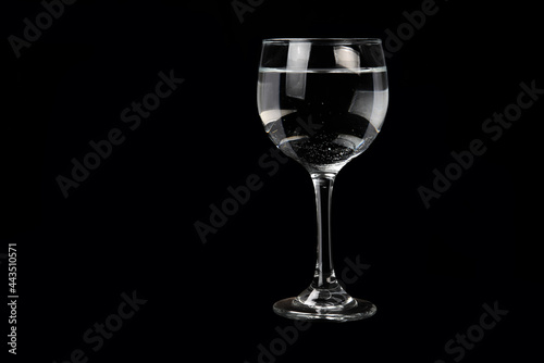 TRANSPARENT CRYSTAL BOWL ISOLATED ON BLACK BACKGROUND