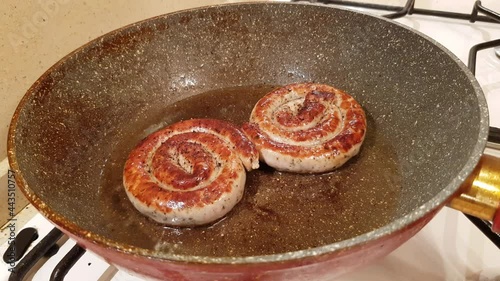 German style spiral fried sausages for beer. Fried in a pan in vegetable oil