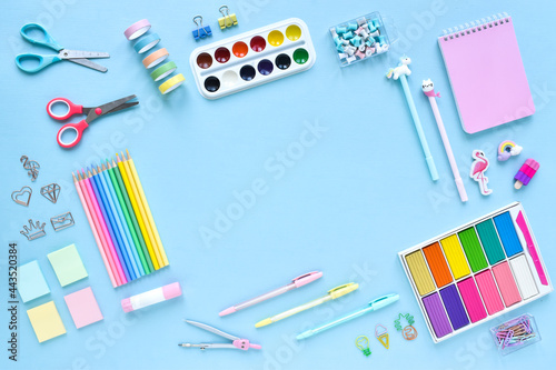 Background of school supplies in pastel colors on a light blue background, space for text. Office supplies. Back to school. It was flat.