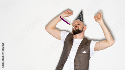 Happy celebration. Birthday man. Holiday fun. Party joy. Excited funny guy casual look wearing festive hat blowing whistle dancing isolated white copy space.