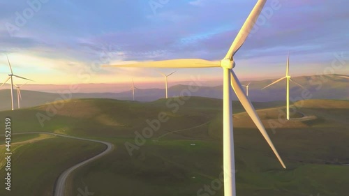 Aerial: Windfarm at sunrise in dreamy environment photo