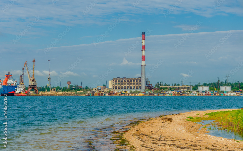 Thermal power plant on the shore of the sea bay.