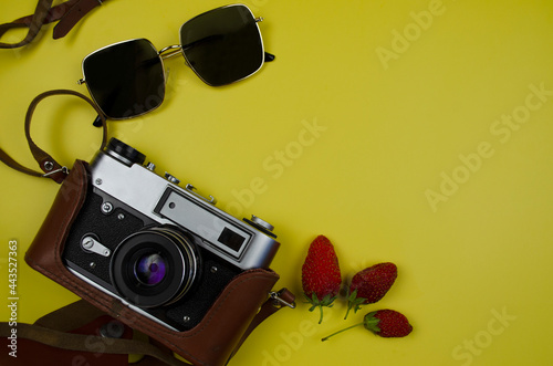 camera and glasses summer yellow background