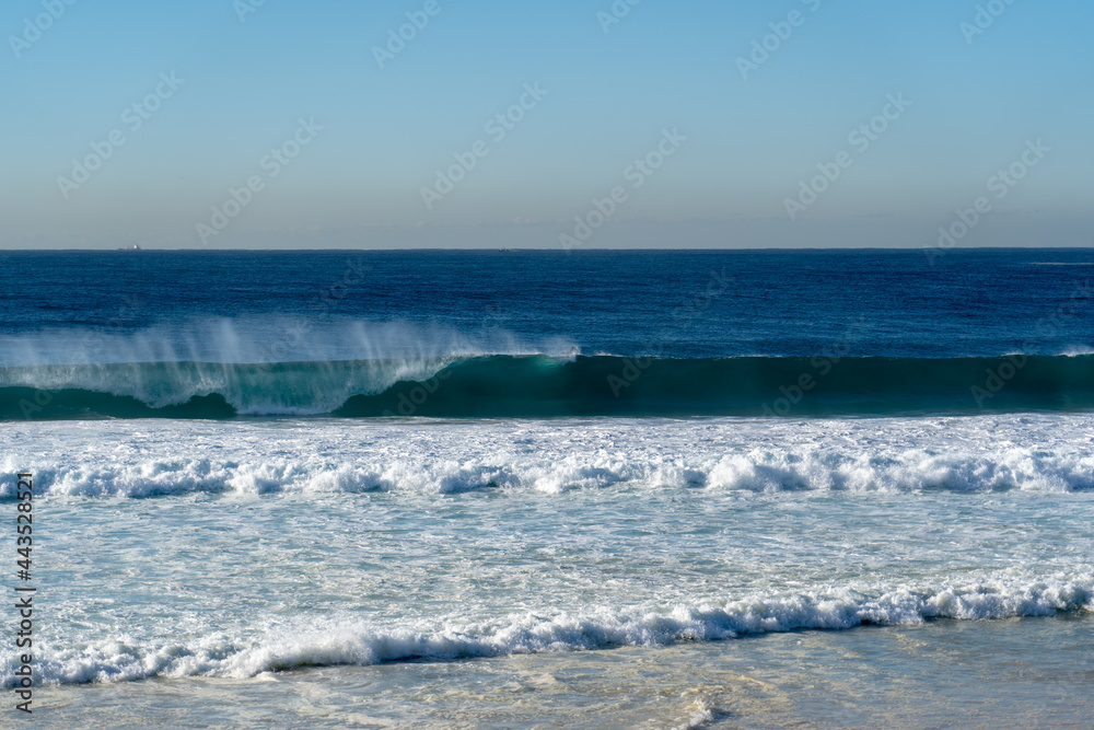 Big waves at the beach crashing onto the shore