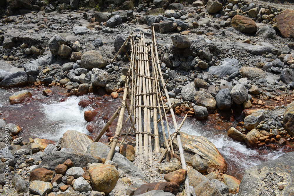 Bamboo bridge over high current himalyan river . Bamboo bridge over high current himalyan river .