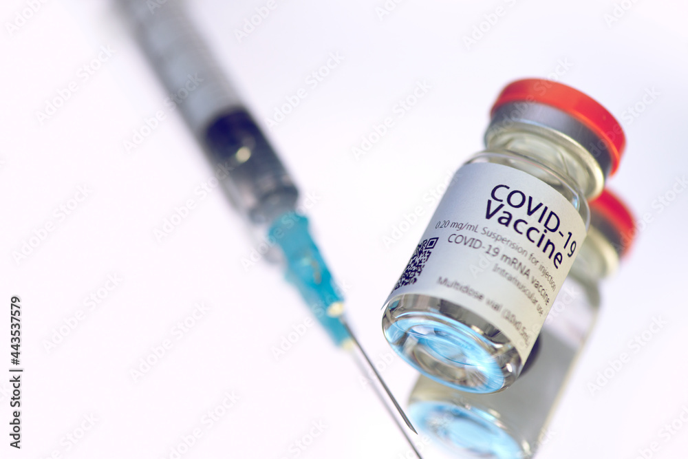 Ampoules with COVID-19 coronavirus vaccine, with a syringe for vaccination. Ampoules with COVID-19 coronavirus vaccine, with a syringe for vaccination.