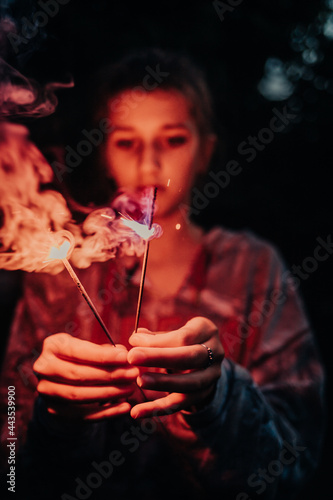 girl playing with sparklers 4th of July