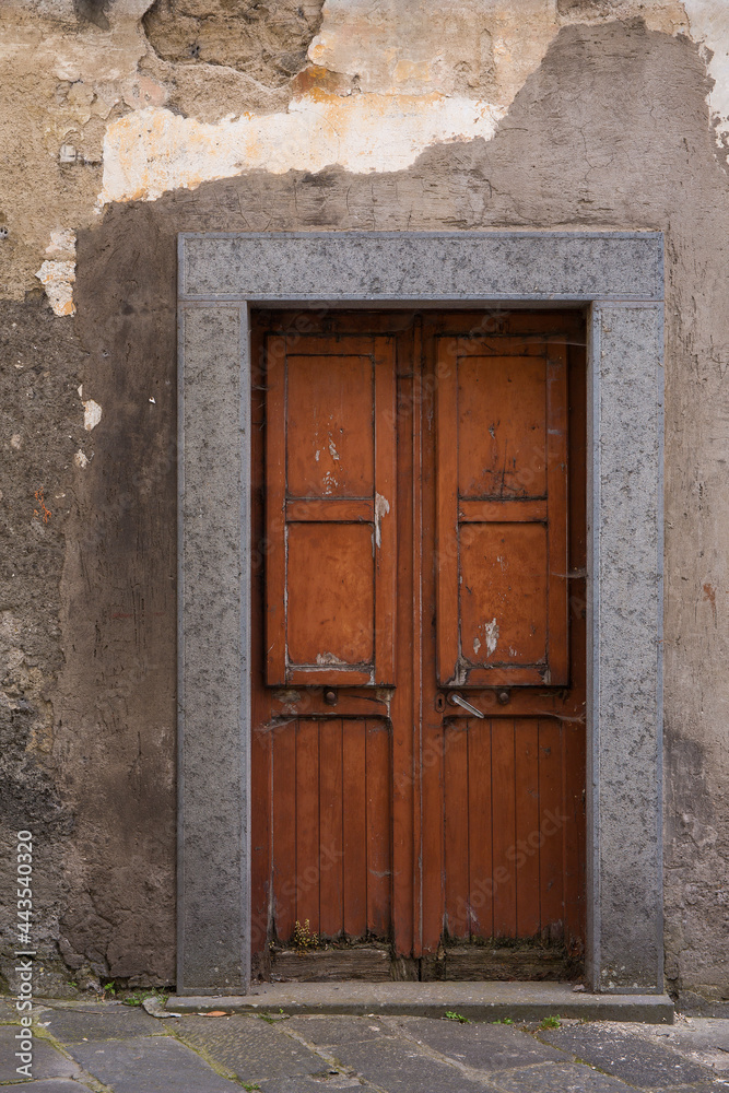 Ancient, rustic door and weathered, peeling paint in the Tuscany region of Italy
