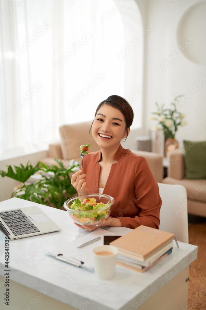 Woman has healthy business lunch in modern office interior. Woman has healthy business lunch in modern office interior.