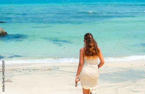 young pretty woman walking relaxing, on  summer beach photo