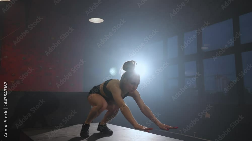 Free running, young female doing a flip on the training ground for parkour and workout, woman perform a handstand and gymnastic tricks in a dark space, 4k slow motion. Free running, young female doing a flip on the training ground for parkour and workout, woman perform a handstand and gymnastic tricks in a dark space, 4k slow motion.