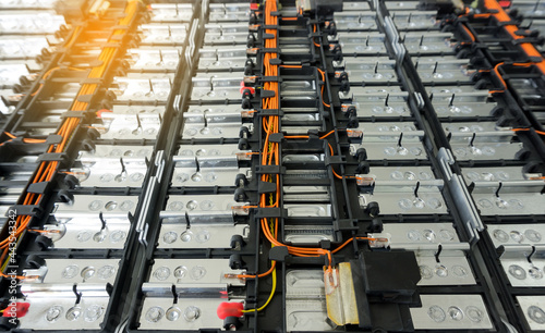 Selective focus of Electric car lithium battery pack and wiring connections internal between cells on background.