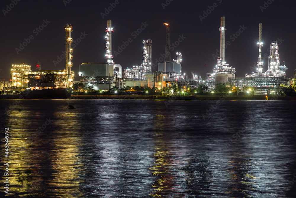 Oil refinery on water front at night Oil refinery on water front at night