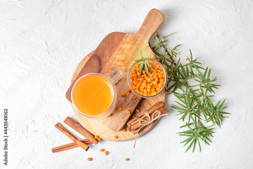 Cup of healthy sea buckthorn tea on white background Cup of healthy sea buckthorn tea on white background