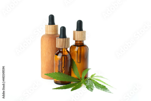 Dropper bottles and cannabis leaves isolated on white background