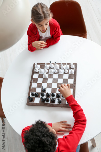 Cute children playing chess...