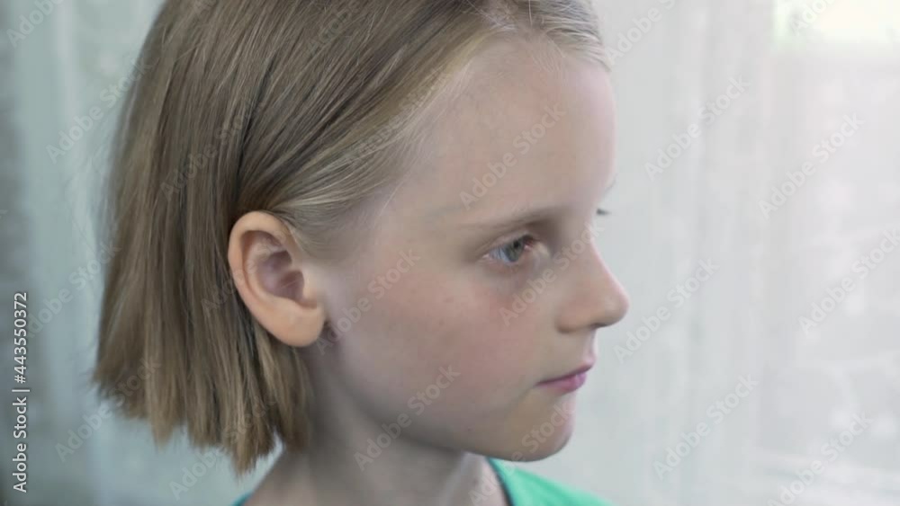 The Face Of A Fair-Haired European Child, Side View. Portrait Of A Little Blonde Girl, Kid.