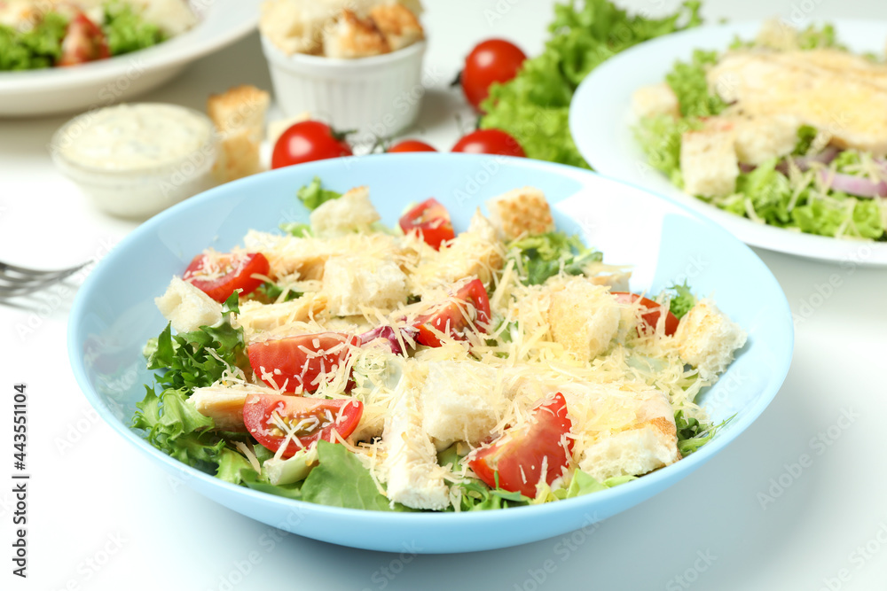 Concept of tasty eating with Caesar salad on white background