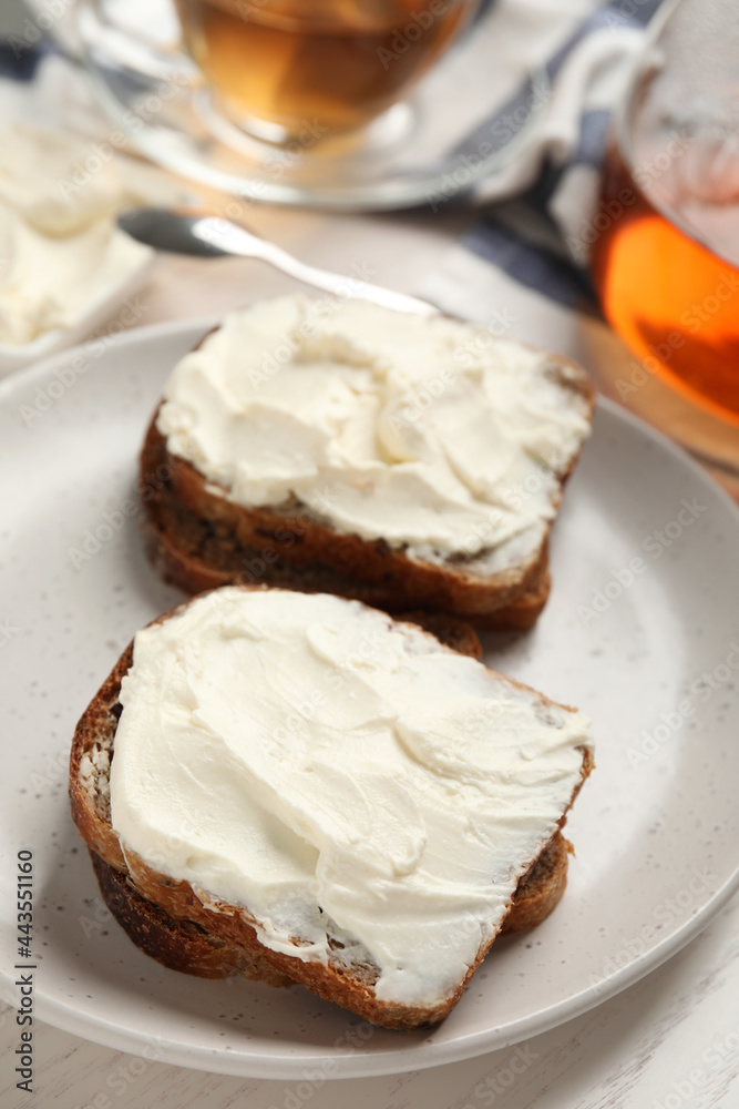 Bread with cream cheese on plate, closeup Bread with cream cheese on plate, closeup