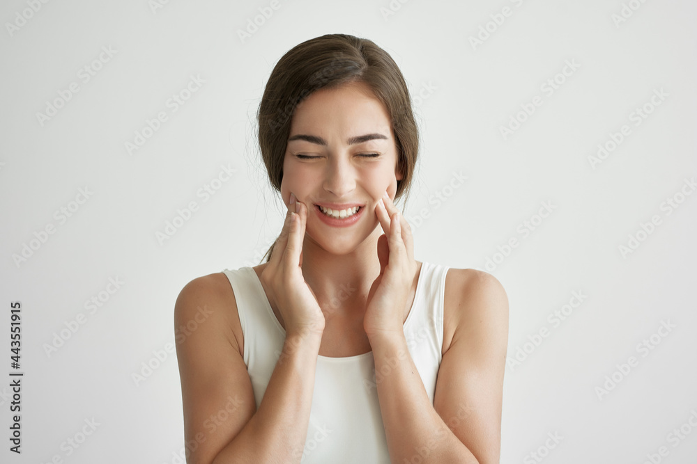 woman in white t-shirt holding face toothache discontent close up woman in white t-shirt holding face toothache discontent close up