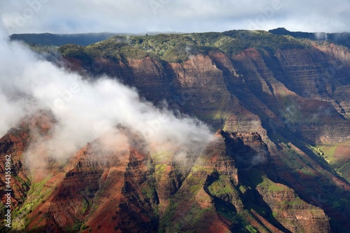  afternoon fog rolls in over colorful waimea canyon, kauai, hawaii 