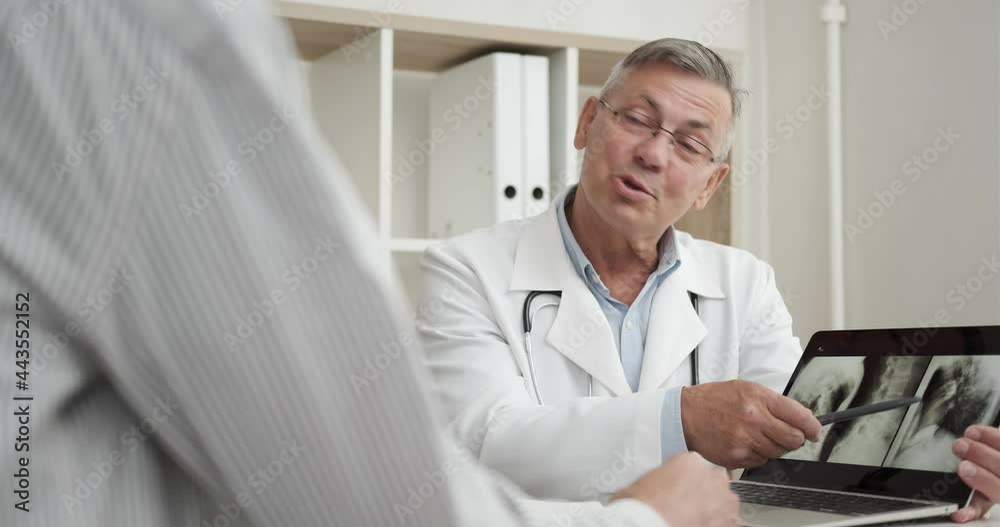 doctor shows an X-ray or ultrasound scan and tells diagnosis doctor shows an X-ray or ultrasound scan and tells diagnosis