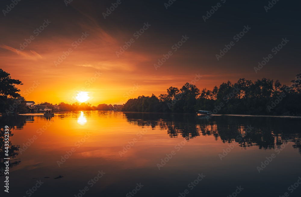 sunset at coast of the river. Nature landscape and reflection sunset.