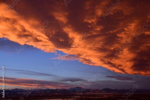 dramatic front of clouds moving in  across long s peak and the front range  at sunset  as seen from broomfield  colorado 