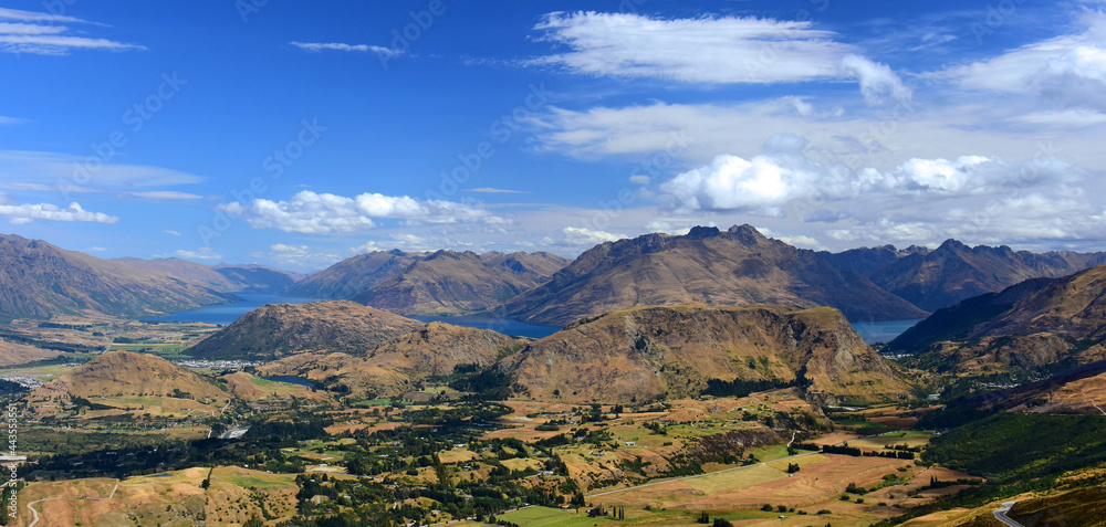 spectacular view  across speargrass flat  and dalefield to lake wakatipu and mountain peaks,  from coronet  peak. near queenstown on the south island of new zealand